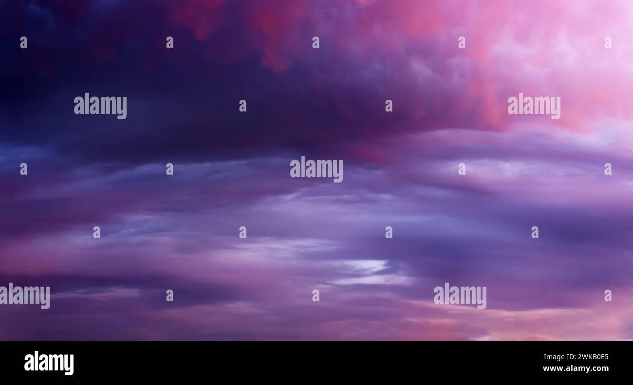 Dramatic sunset sky background with dark clouds. Natural background. Soft focus. Stock Photo