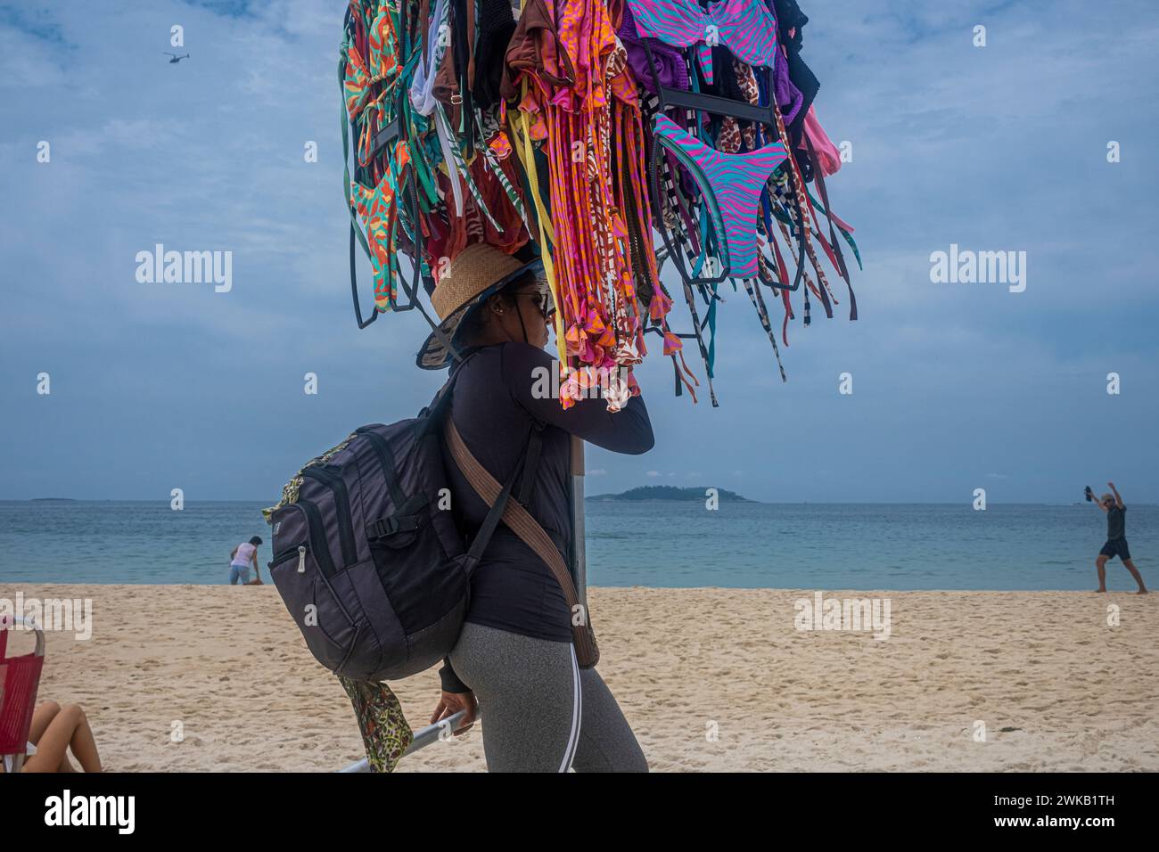 Beach vendor sells colorful bikinis at Ipanema beach, Rio de Janeiro, Brazil. Stock Photo