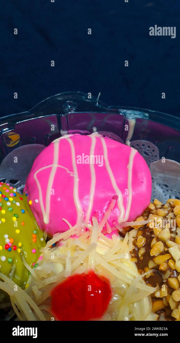 Close up of donuts with various color variants and toppings Stock Photo ...