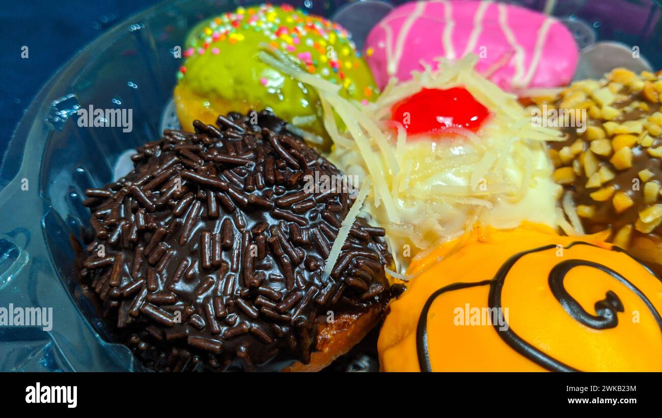 Close up of donuts with various color variants and toppings Stock Photo ...