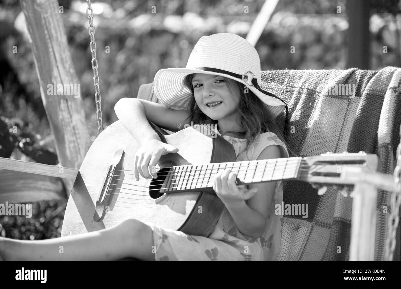 Child with guitar outdoor. Summer activity for children in warm weather