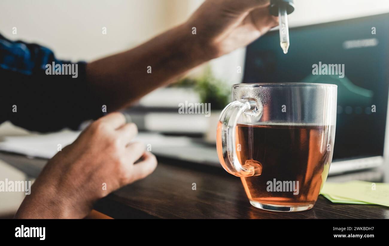 Cbd oil. Business woman taking in drink for anxiety and stress treatment at work office. Alternative medicine Stock Photo