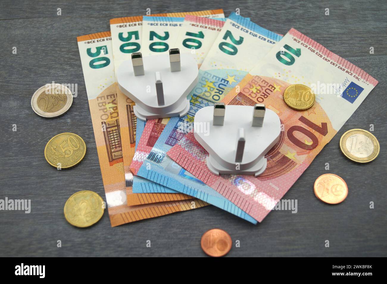 Plugs and money, symbolic image of electricity costs Stock Photo