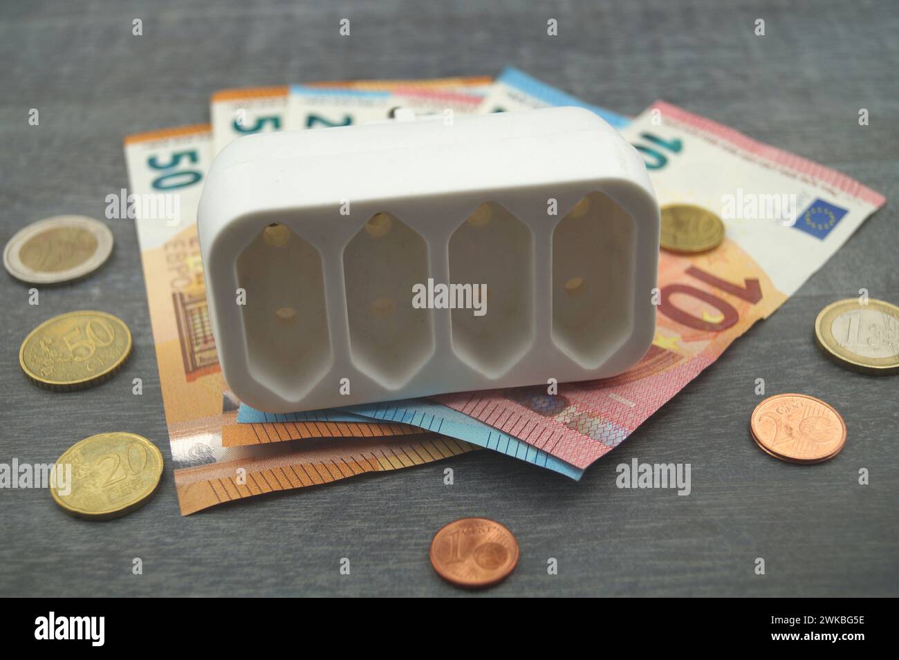 Socket and money, symbolic image of electricity costs Stock Photo