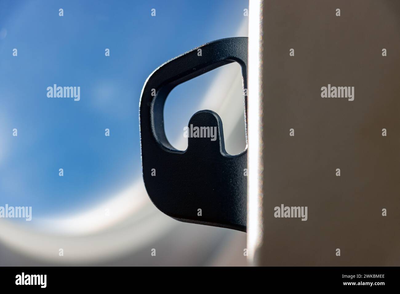 An empty clothes hanger on a seat in a flying airplane, close up Stock