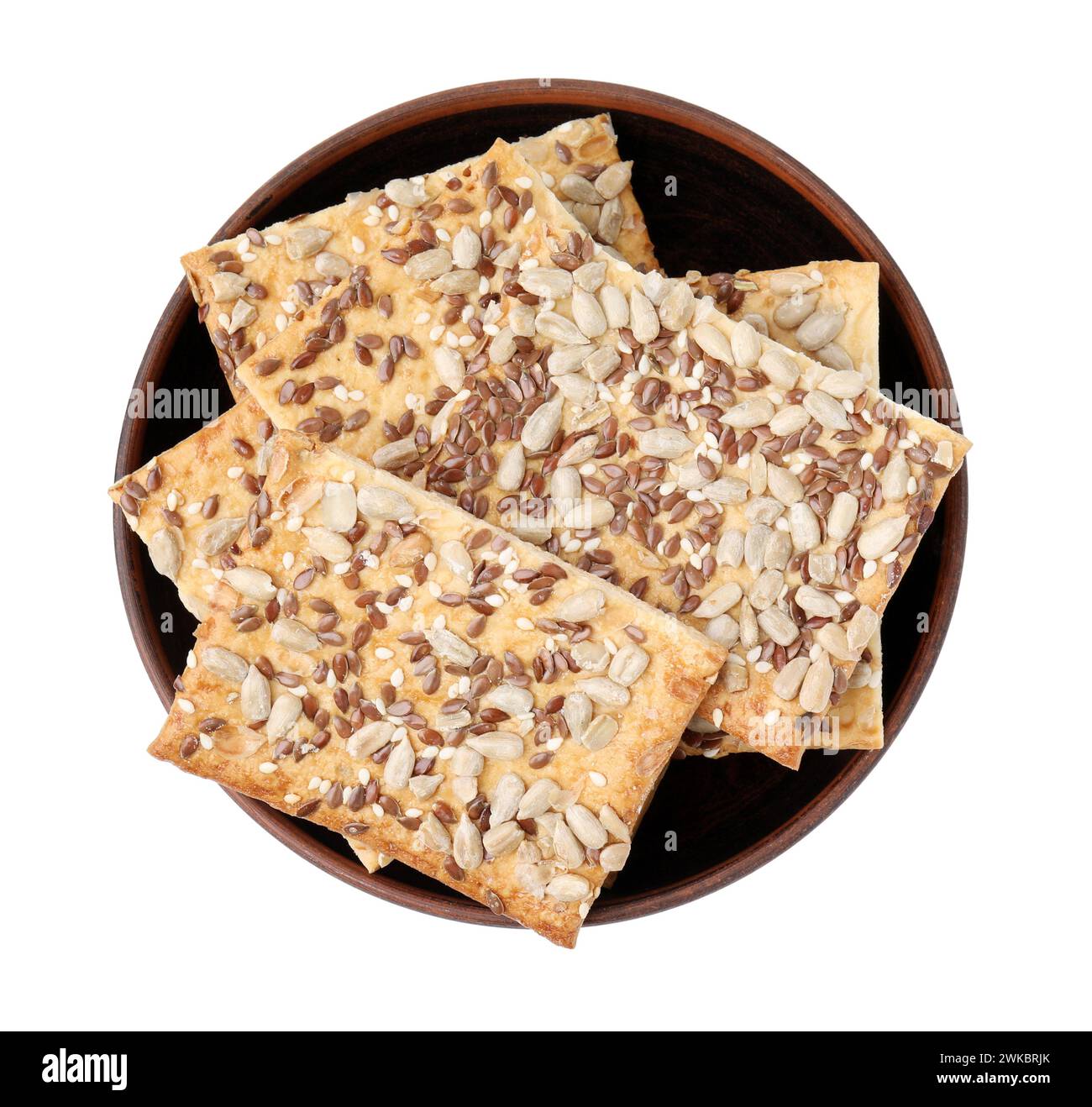 Cereal crackers with flax, sunflower and sesame seeds in bowl isolated ...