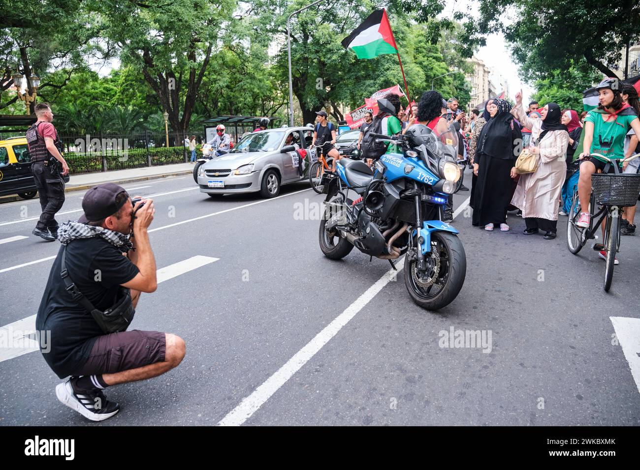 Buenos Aires, Argentina, Feb 16, 2024: man taking pictures of a popular demonstration, a group of people protesting in solidarity with Palestine and a Stock Photo