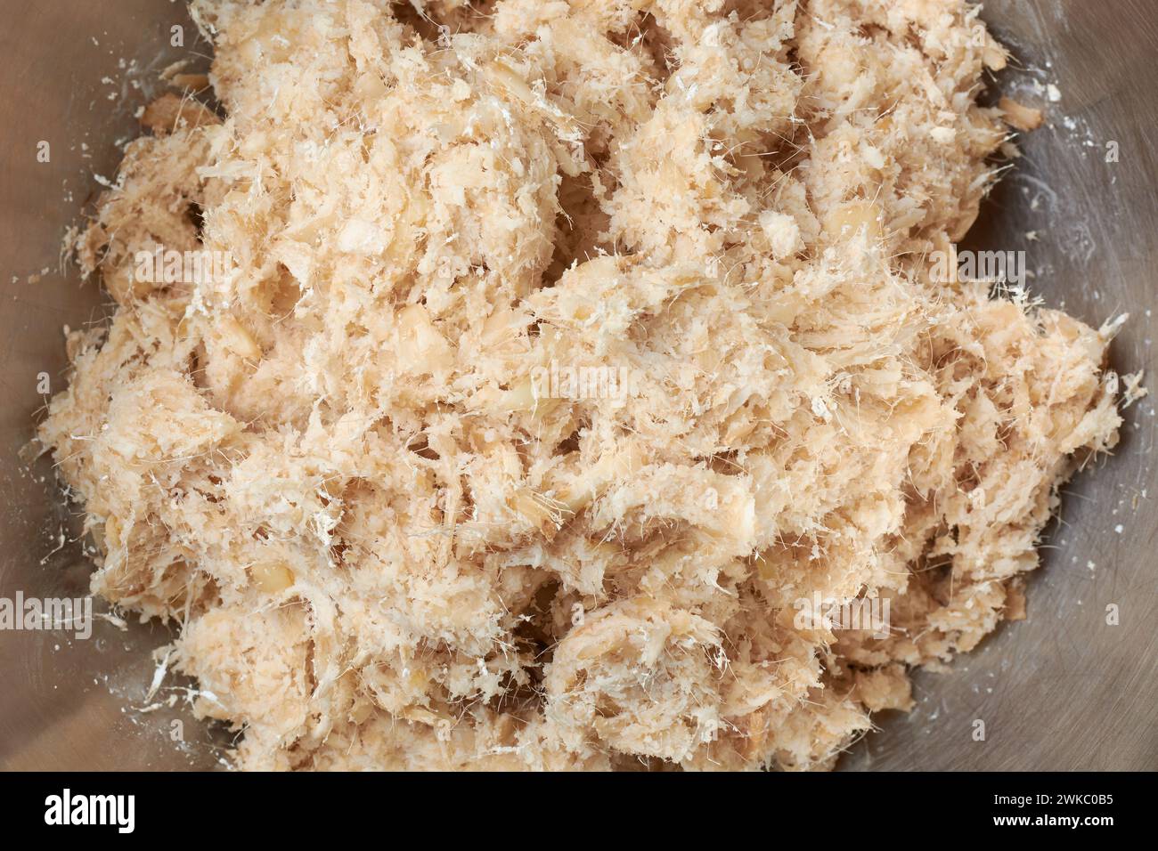 pulp of dried organic arrowroot rhizomes pieces to process into powder, maranta arundinacea, washed, peeled and finely ground into pulp Stock Photo