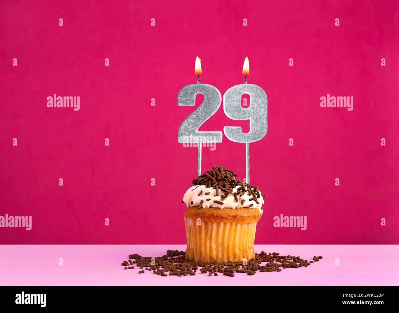 Birthday cupcake with candle number 29 - Birthday card on pink background Stock Photo