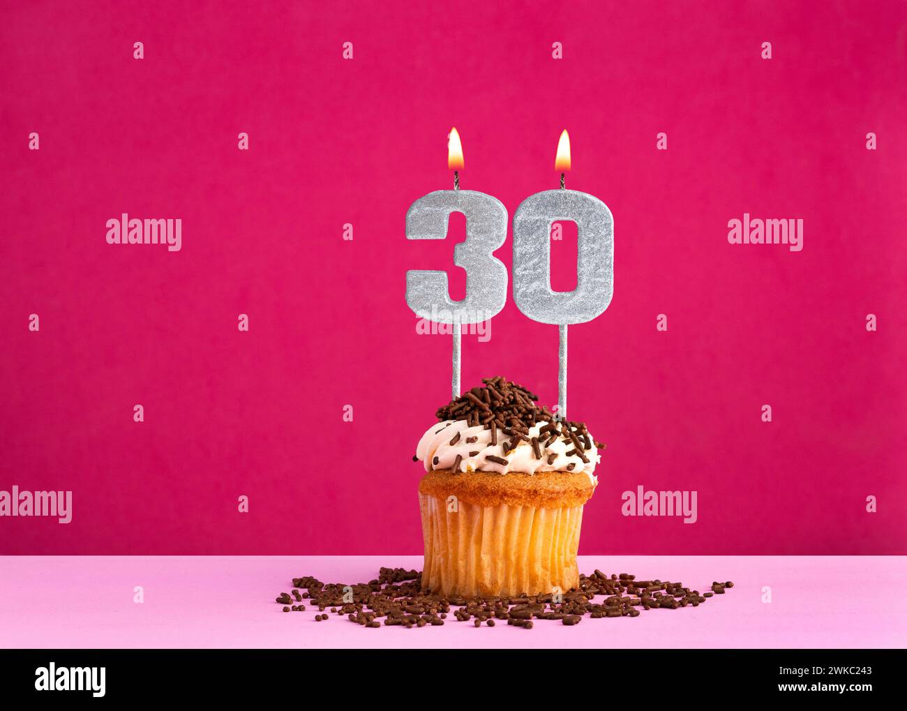 Birthday celebration with candle number 30 - Chocolate cupcake on pink ...