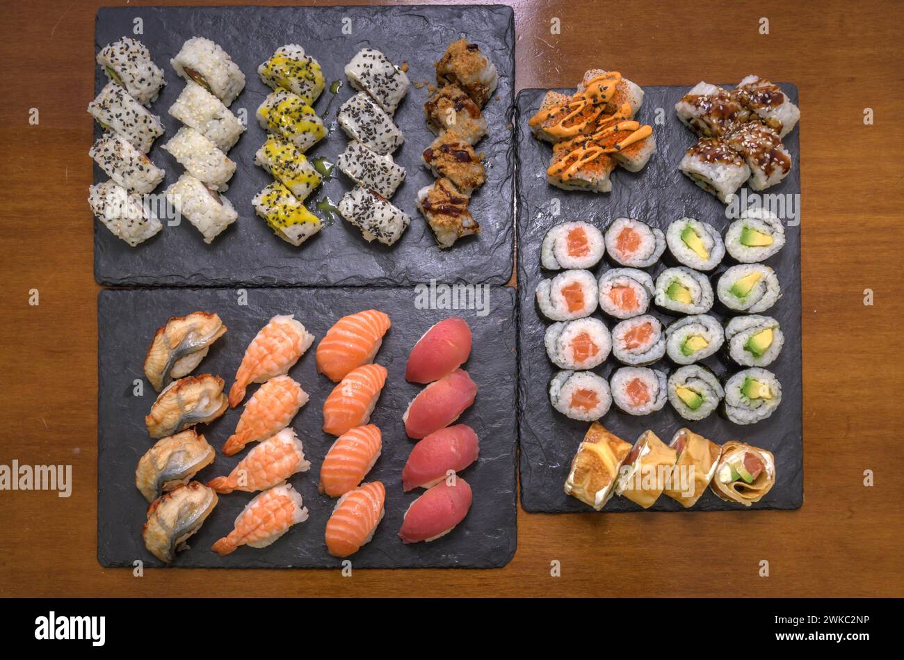 A selection of various sushi including rolls and nigiri on two slate serving platters, Majorca, Balearic Islands, Spain Stock Photo