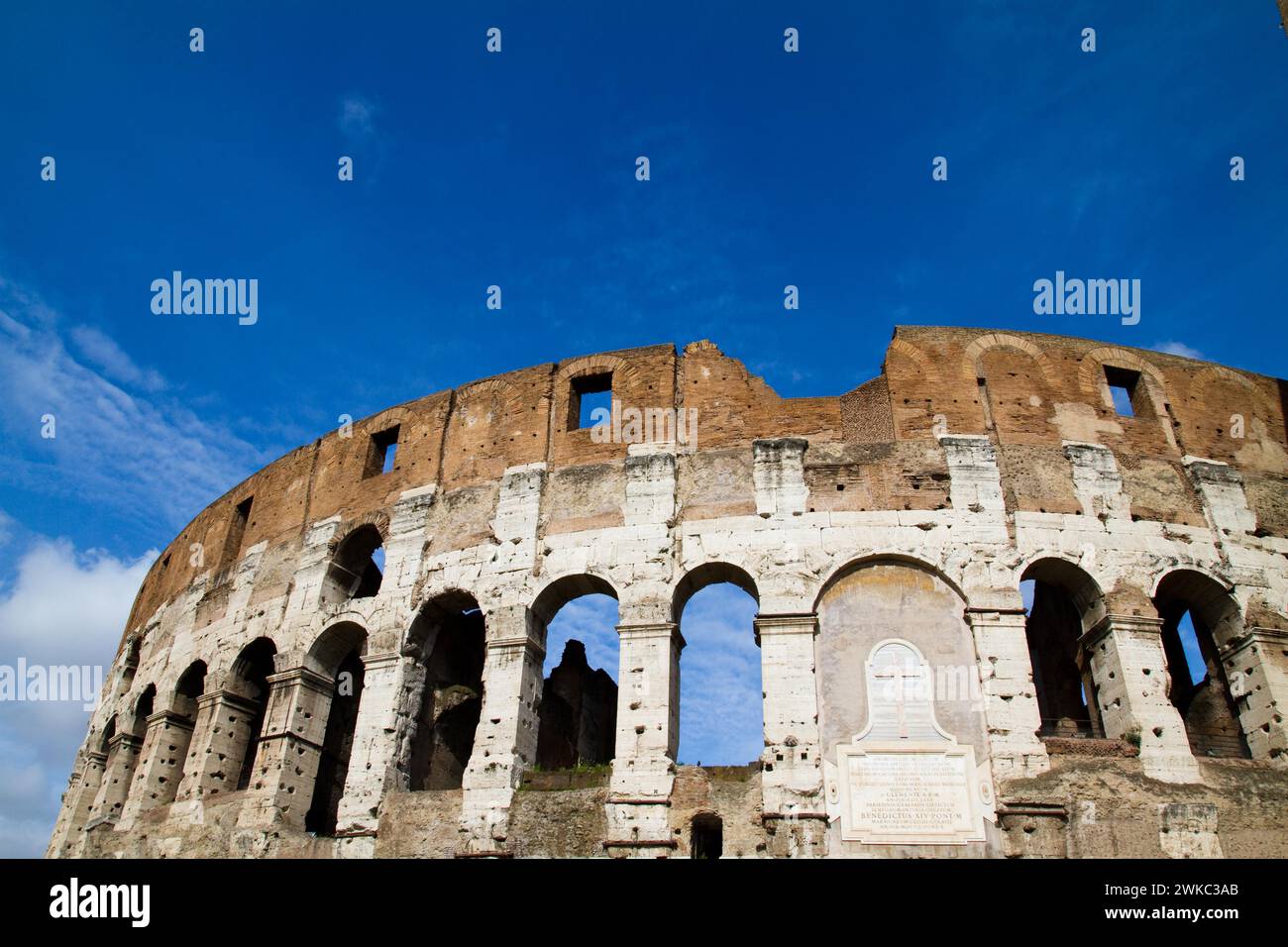 The Colosseum in Rome under a clear blue sky, a symbol of ancient Roman ...