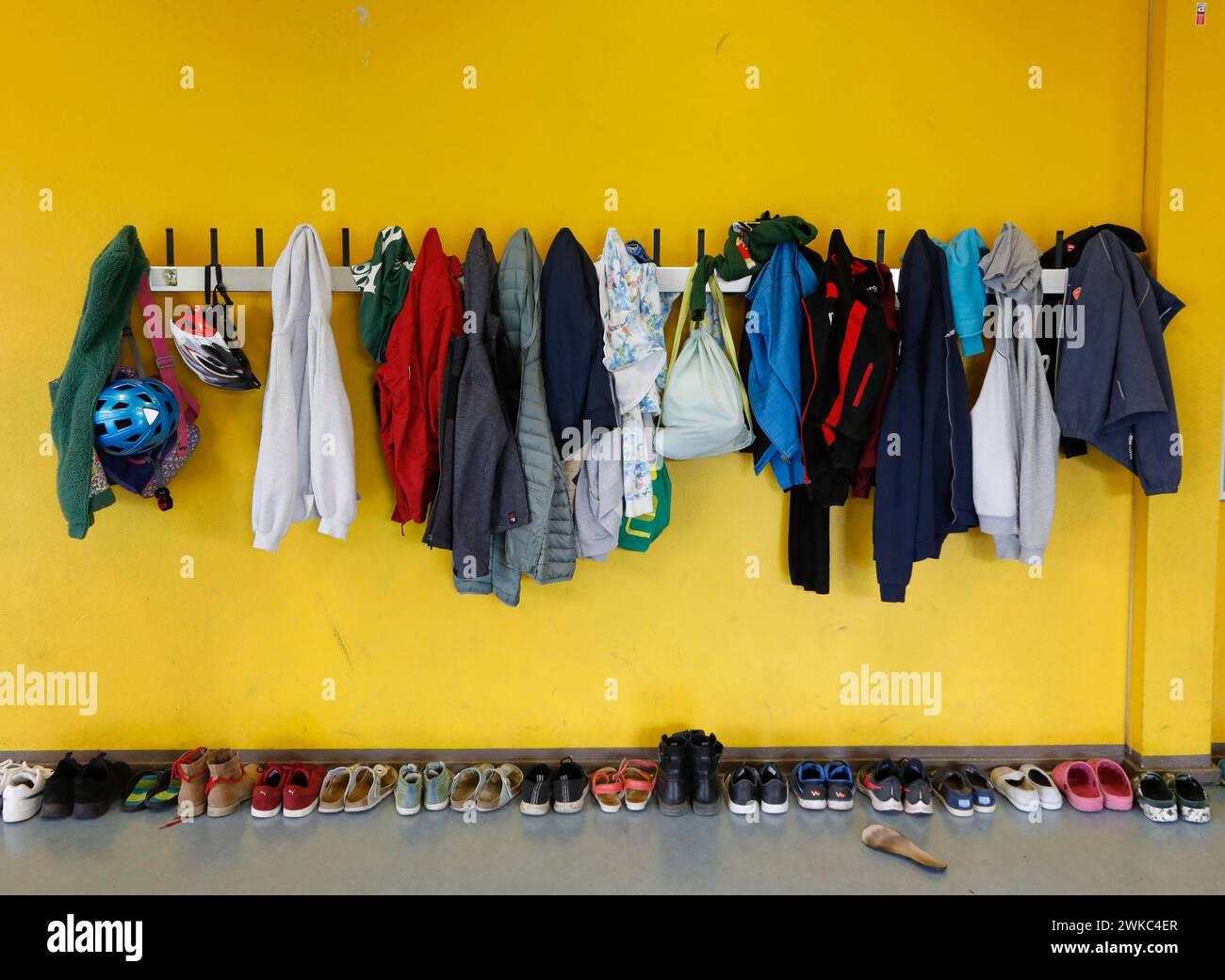 Jackets and bags hanging on a cloakroom in a Berlin primary school, shoes on the floor, 14/08/2019 Stock Photo
