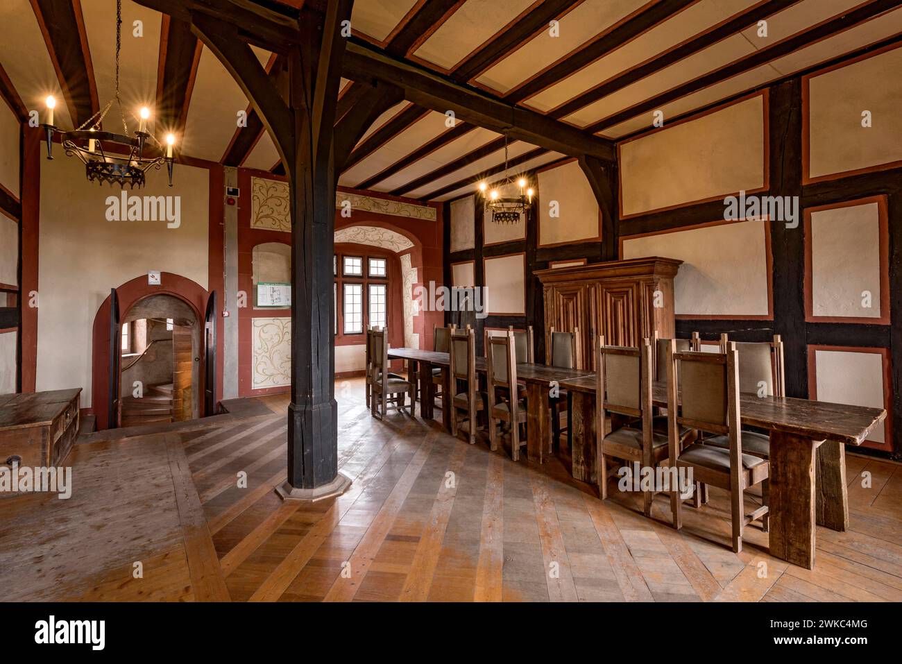Junkernstube, long solid wooden table for young gentlemen, chandelier, Rieneckische Gemaecher, knight's castle from the Middle Ages, Ronneburg Stock Photo