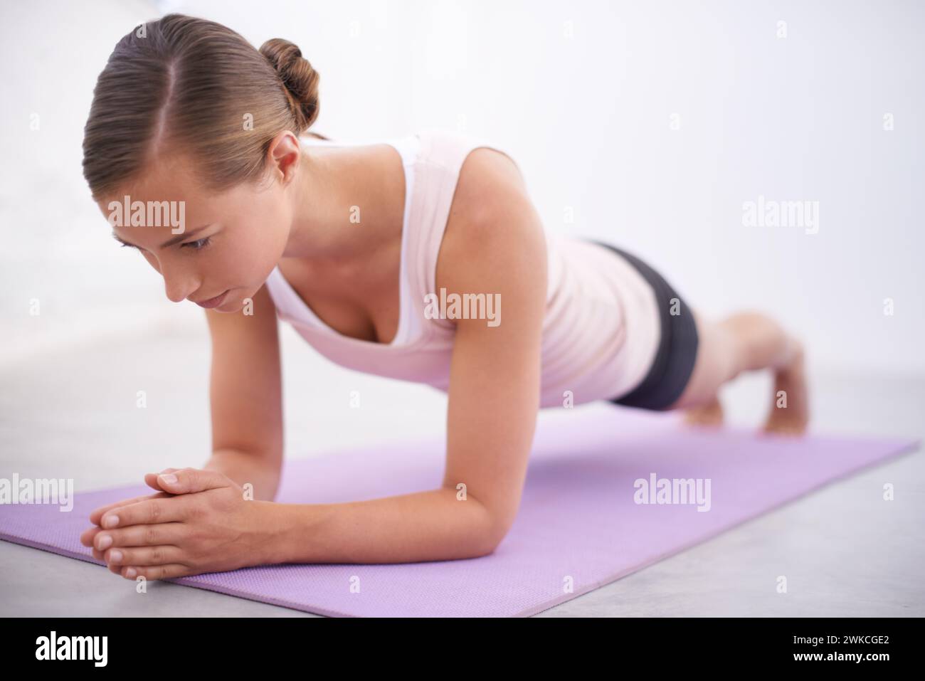 Yoga, pushup and woman with stretching for fitness, natural exercise and balance in home. Workout, pilates and healthy body of girl on mat for morning Stock Photo