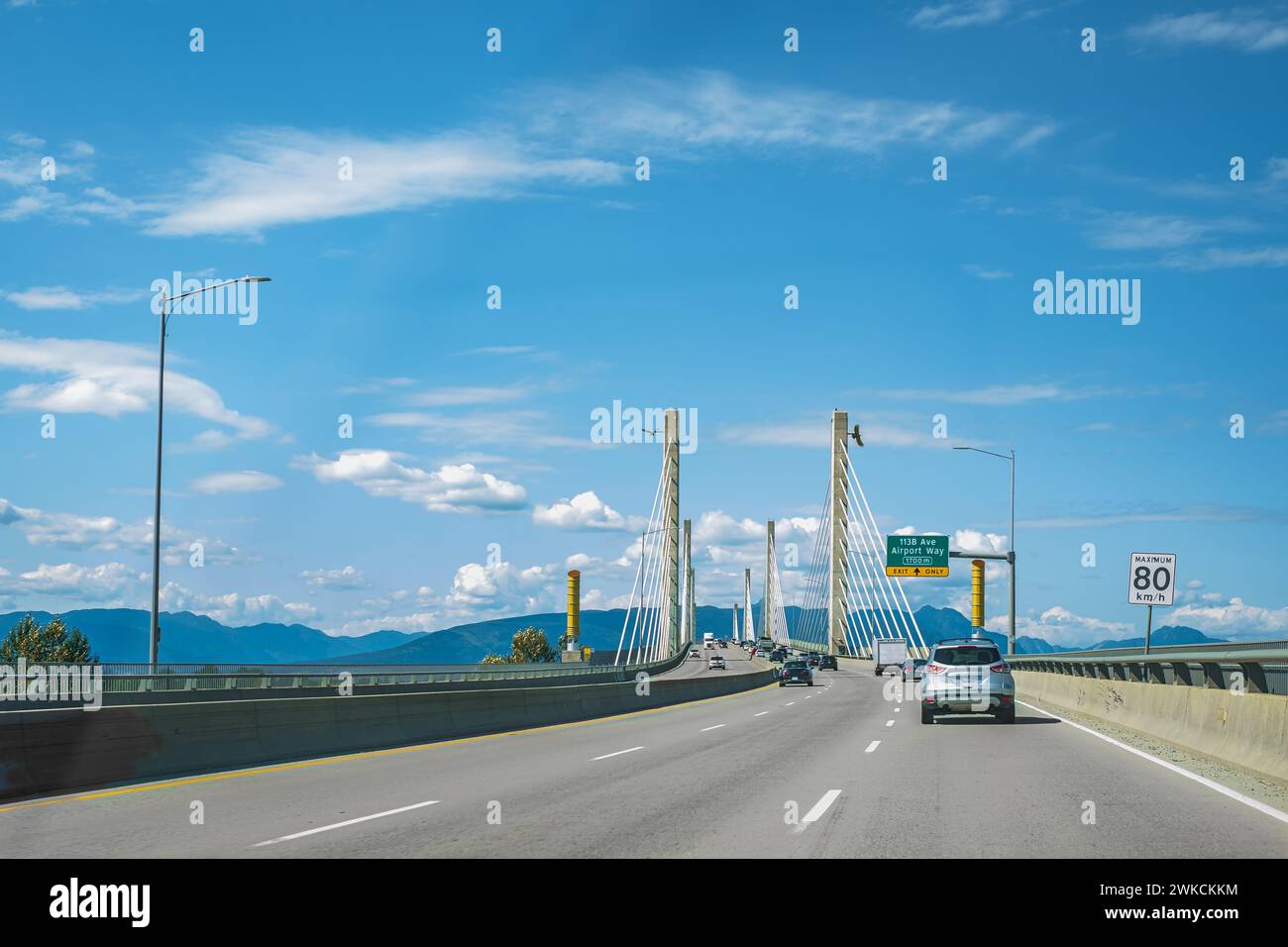 Golden Ears Bridge, connecting Maple Ridge to Langley. Traffic on a cable-suspended bridge spanning across Fraser River on a sunny summer day. Vancouv Stock Photo