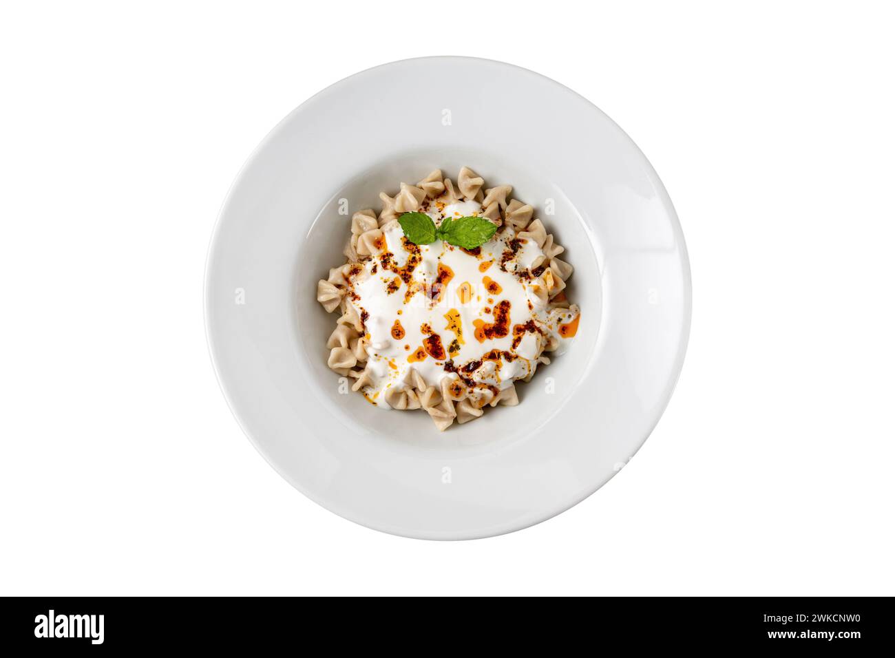Kayseri ravioli or Kayseri Mantisi on a white plate on white background Stock Photo