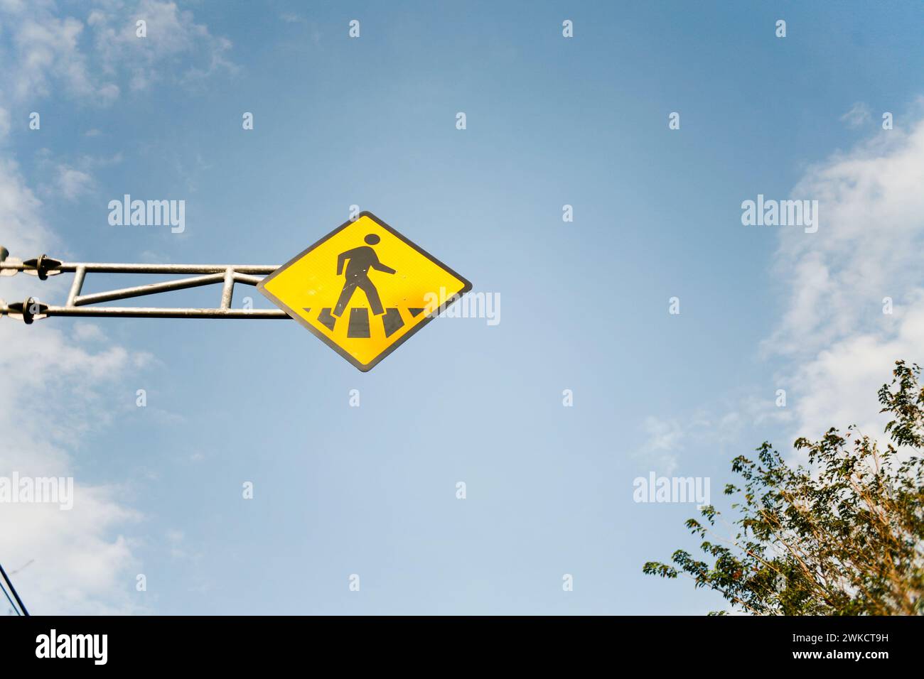Yellow crossing sign on the road in Kediri, East Java, Indonesia Stock Photo