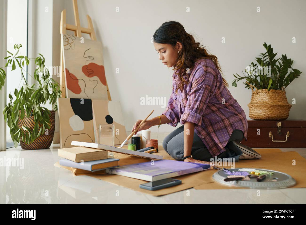Talented girl painting pictures in her studio Stock Photo