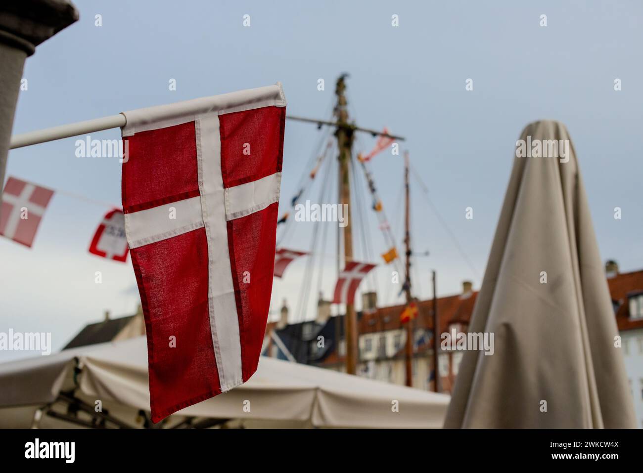 A Danish flag hanging at a boat dock. Stock Photo