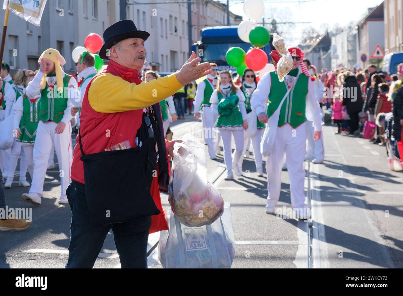 Cologne, Germany - February 11, 2024  Funny Street musicians in colorful clothes celebrating the women's carnival, Rosenmontag Parade( the rose monday. Stock Photo