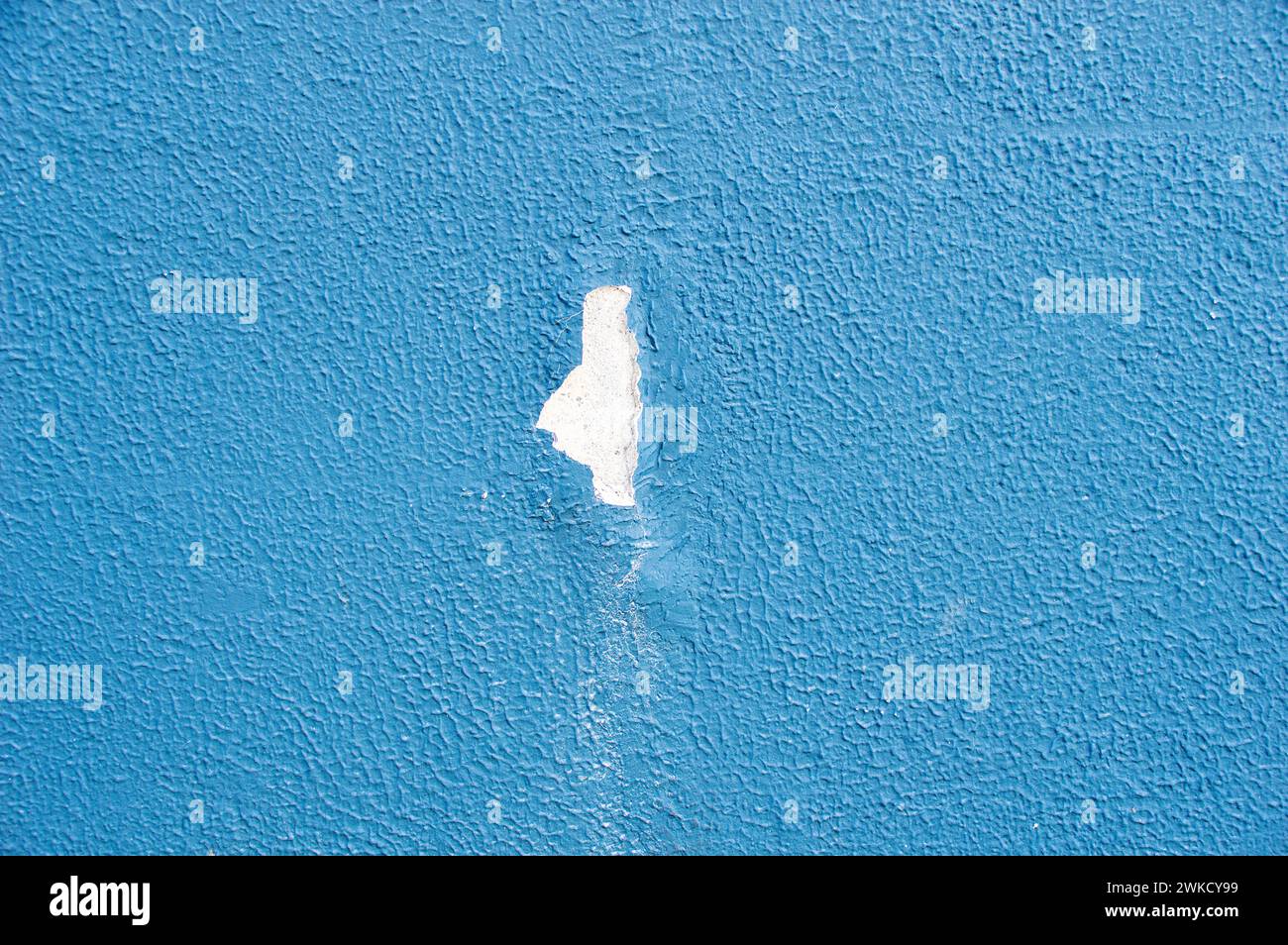 Grunge cracked blue stucco wall background because of water ingress Stock Photo