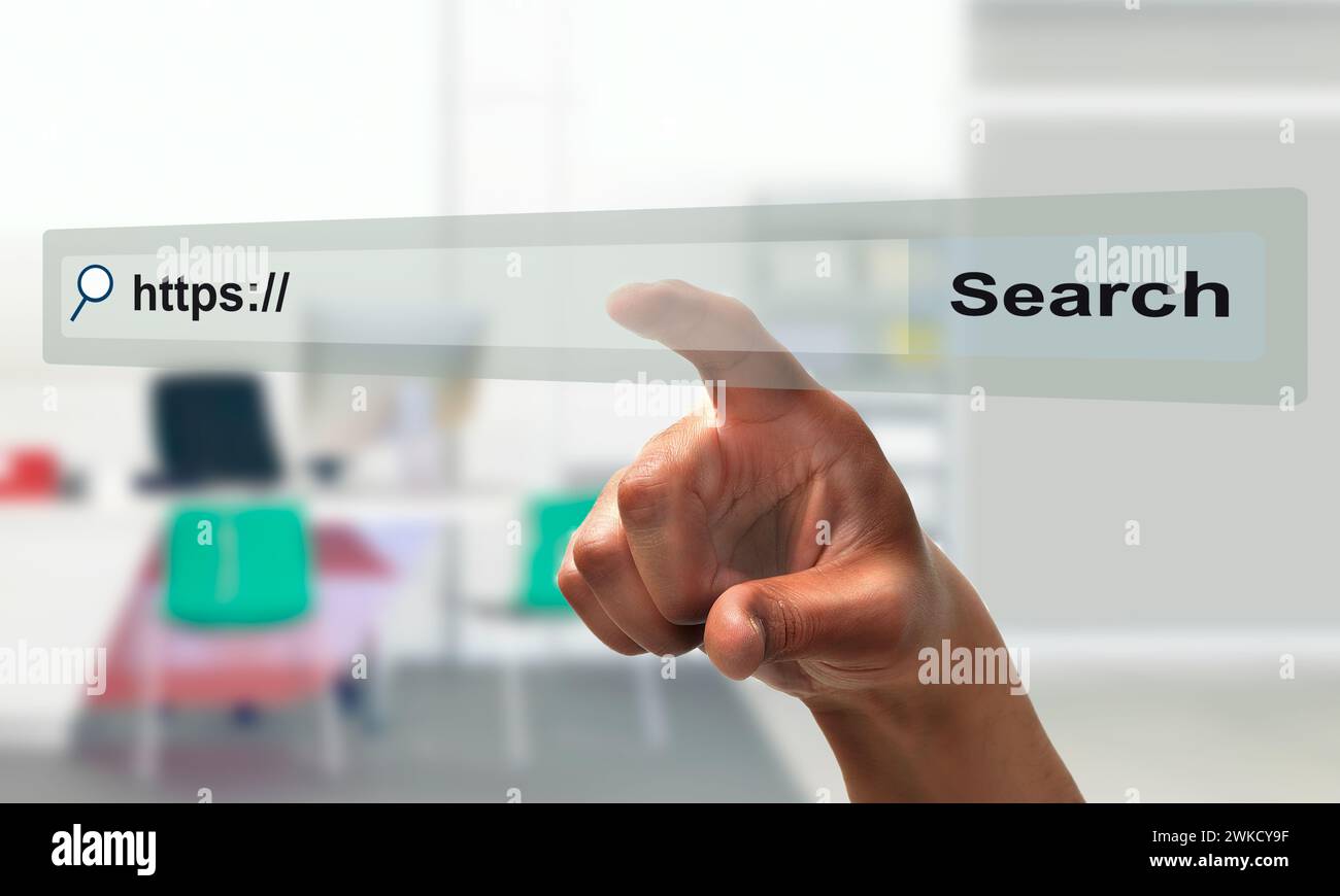 Concept shot of a businessman hand pointing at search bar on virtual screen at office Stock Photo