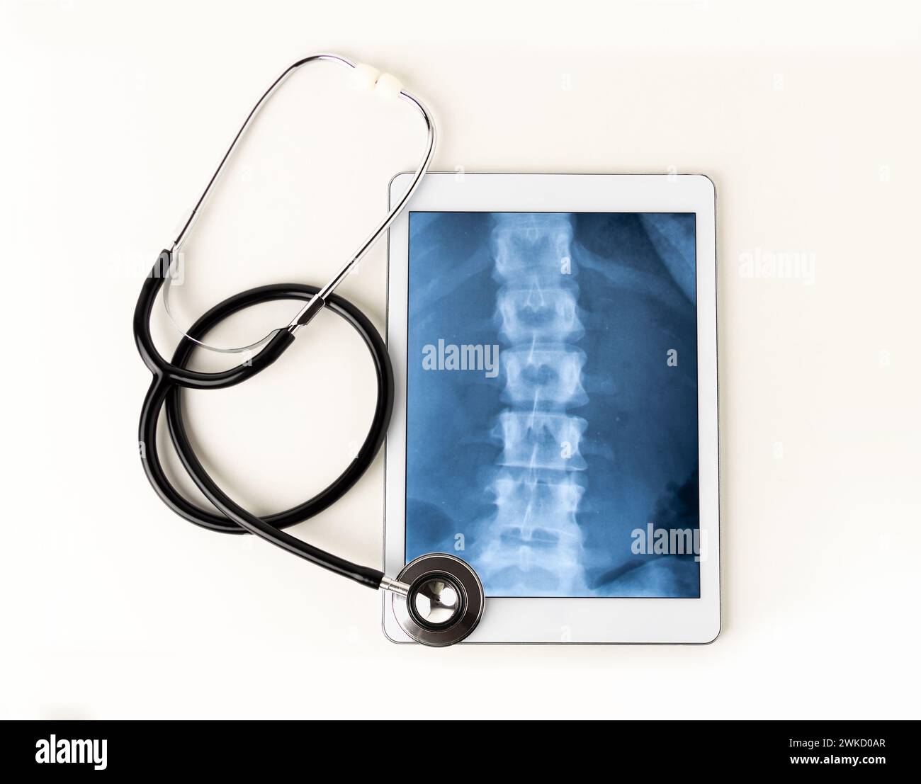 A tablet and a stethoscope against a white background Stock Photo - Alamy