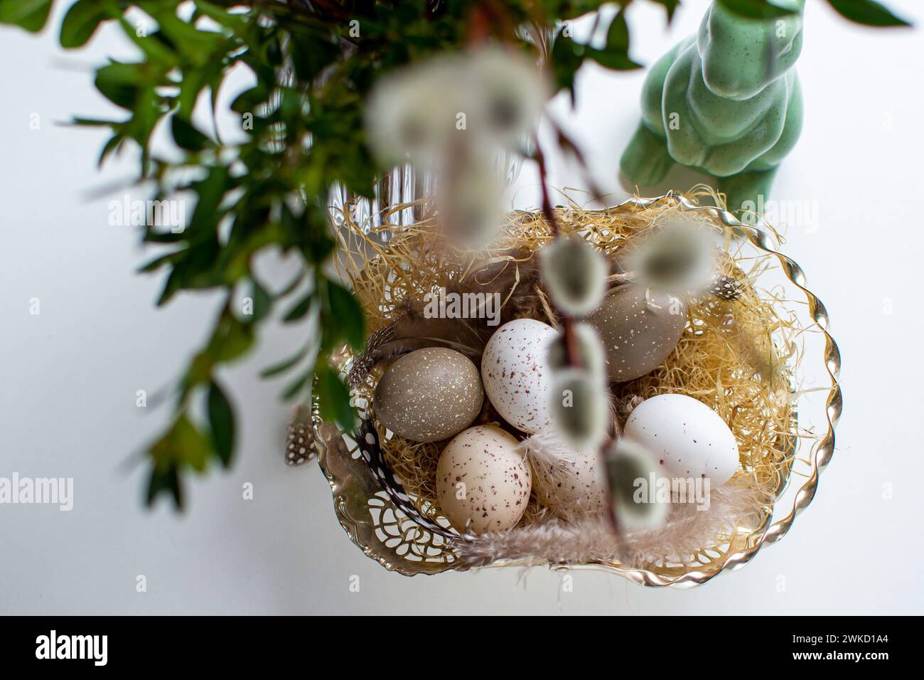 Easter eggs and easter bunny under willow and boxwood branches Stock Photo