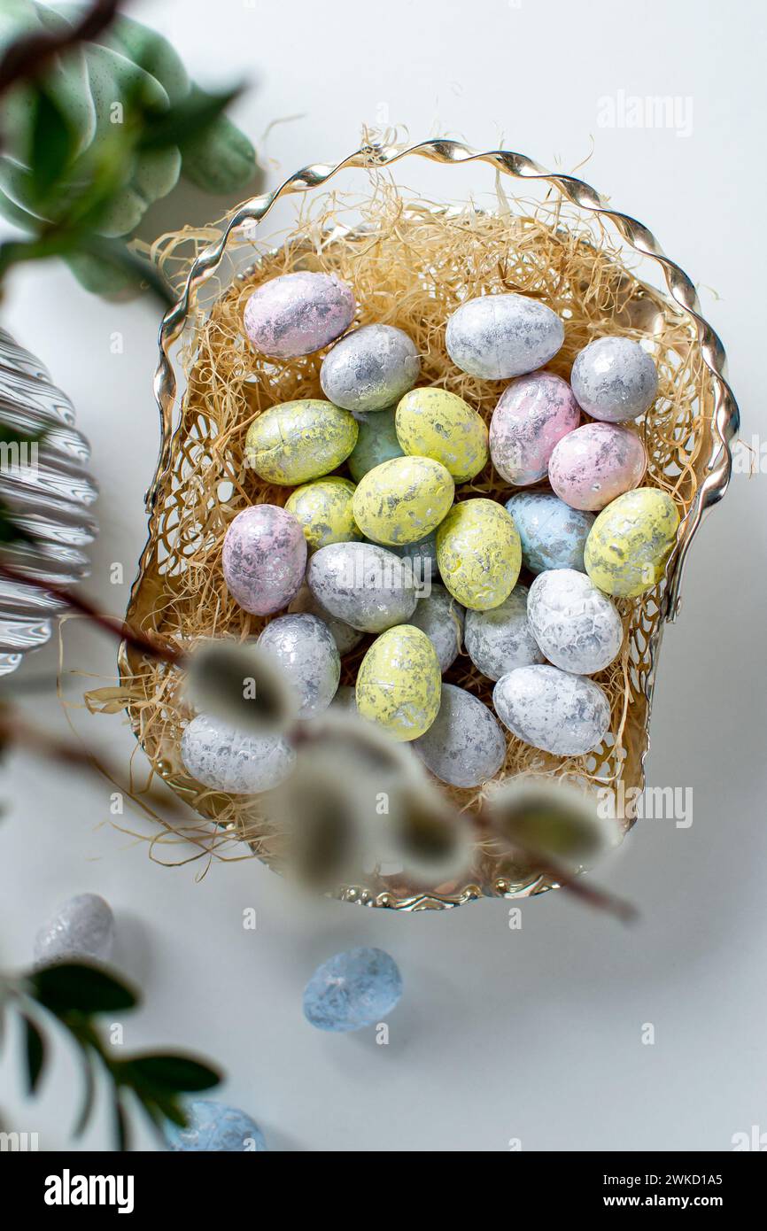Easter eggs and easter bunny under willow and boxwood branches Stock Photo
