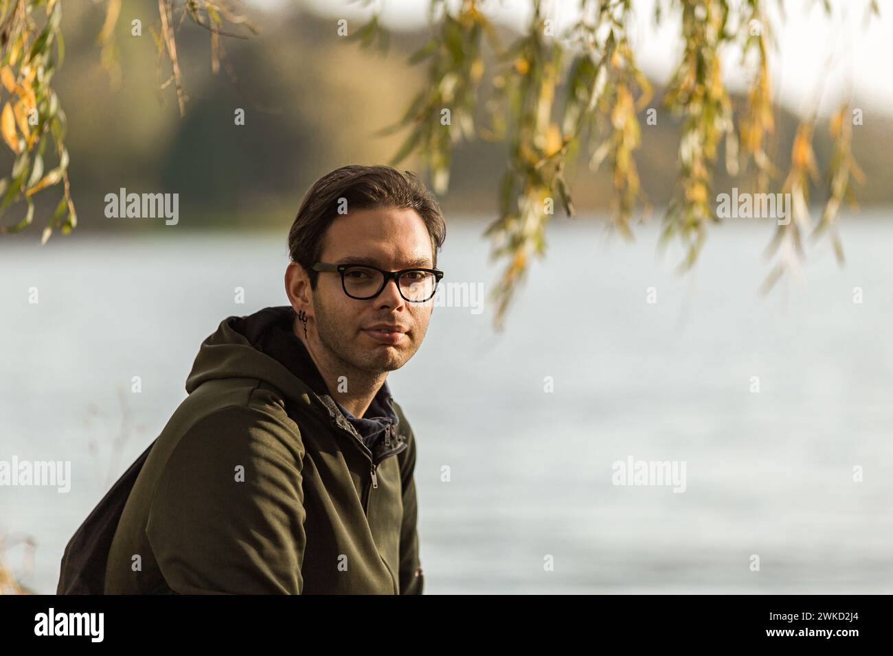 A portrait of a man with glasses outdoor in nature Stock Photo