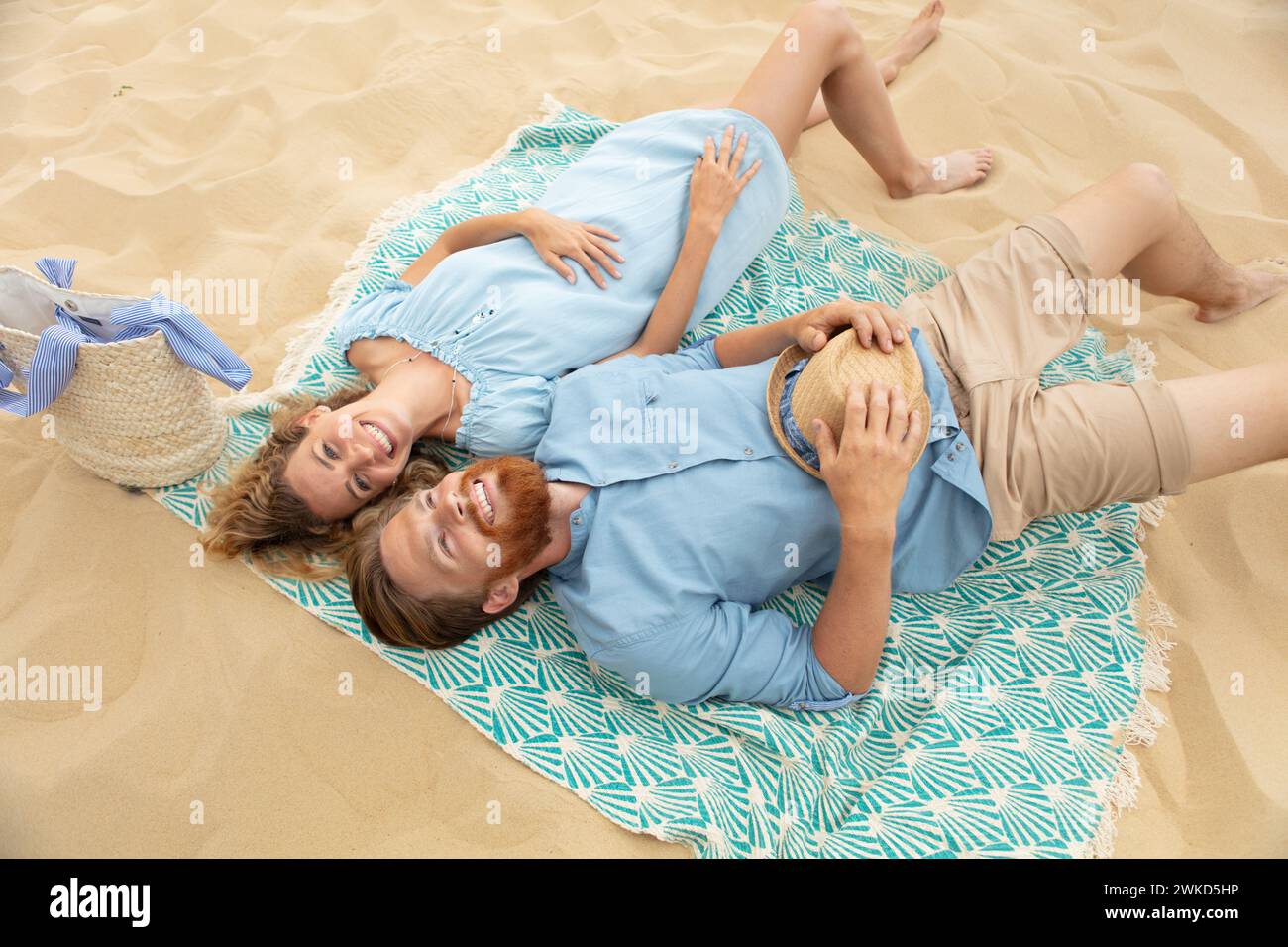 happy young couple laying on the beach Stock Photo - Alamy
