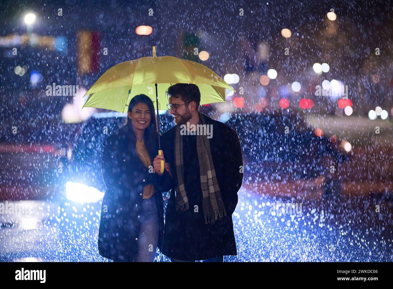 Couple sharing umbrella in rain hi-res stock photography and images - Alamy