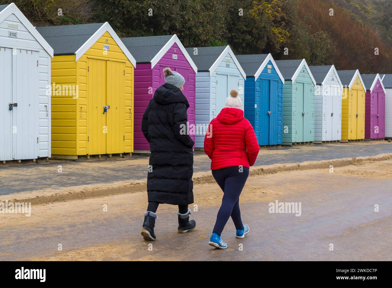 Bournemouth, Dorset, UK. 20th February 2024. UK weather: mizzly damp morning at Bournemouth, doesn't deter people walking along the promenade past colourful beach huts for their exercise. Credit: Carolyn Jenkins/Alamy Live News Stock Photo