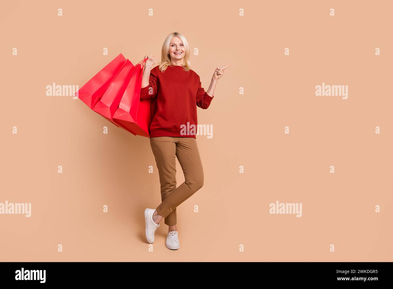 Full length photo of positive sweet woman wear red sweater rising ...