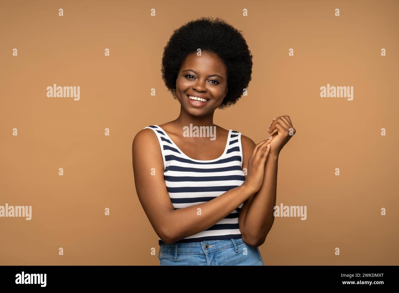 Portrait african american female smiling broadly, posing for shot, looking at camera with happy face Stock Photo