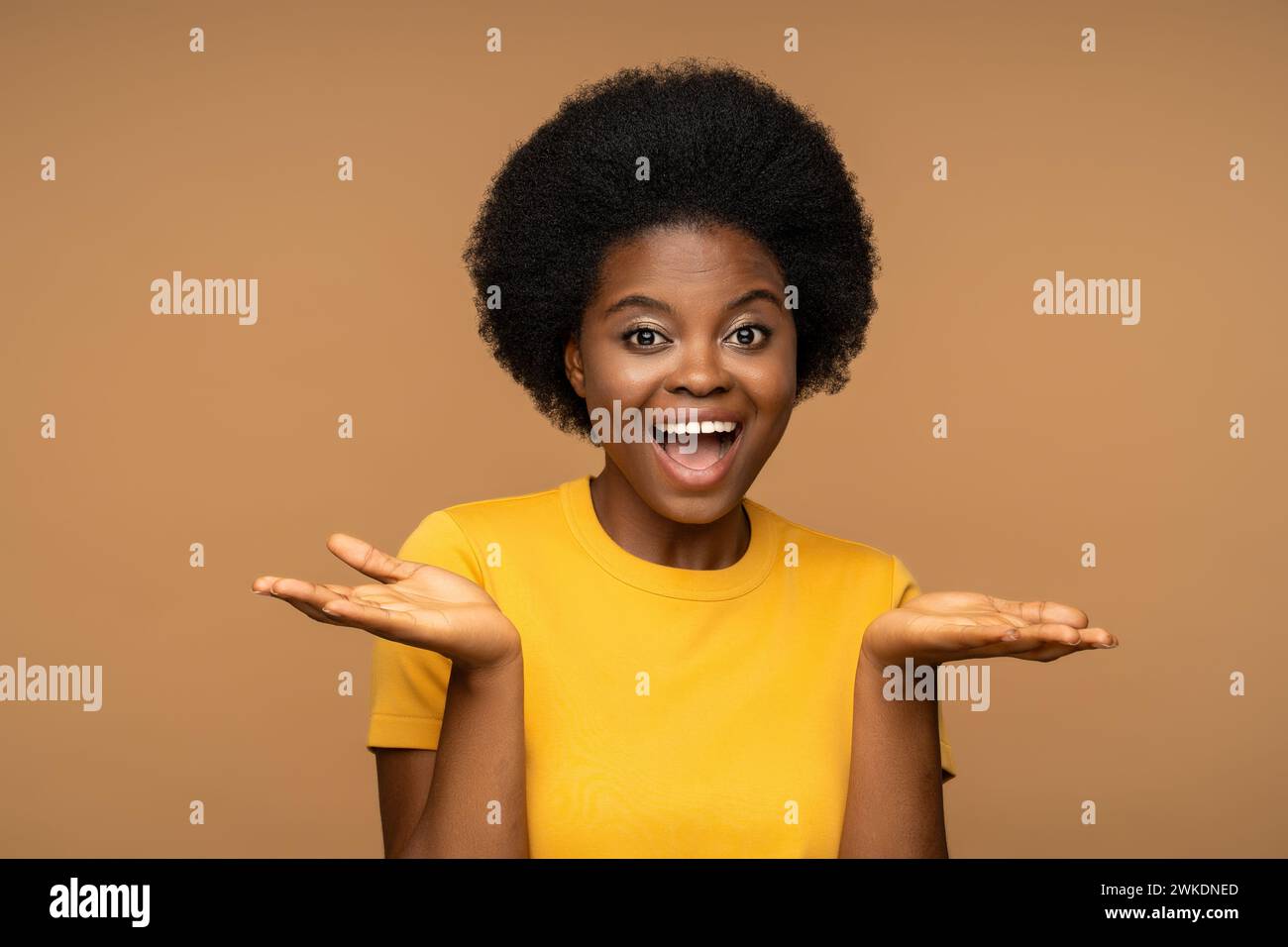 Merry charismatic africam american woman with happy face expression, smiling broadly, look at camera Stock Photo
