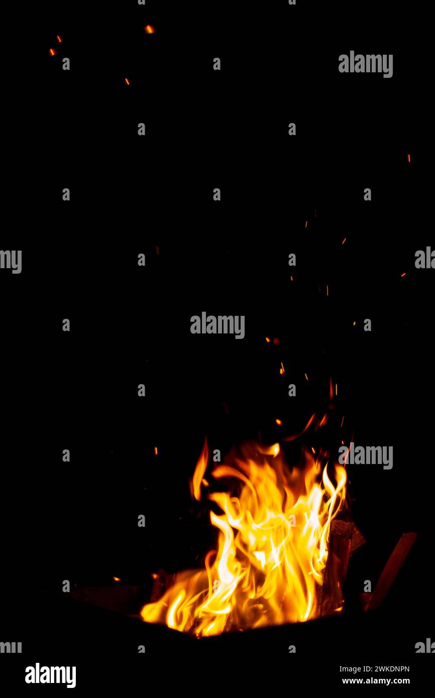 The fire burns at night. Fire and sparks on a black background Stock Photo