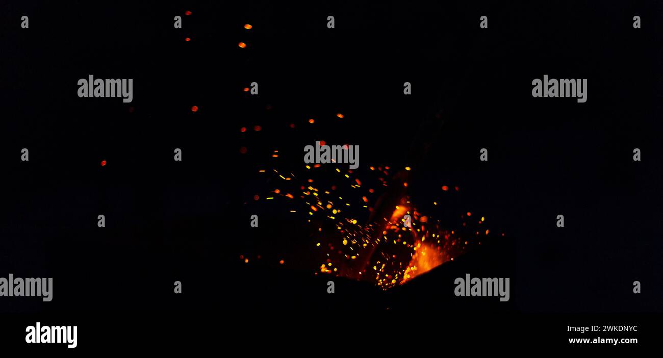 Bonfire with sparks at night. Fire burns in the dark Stock Photo