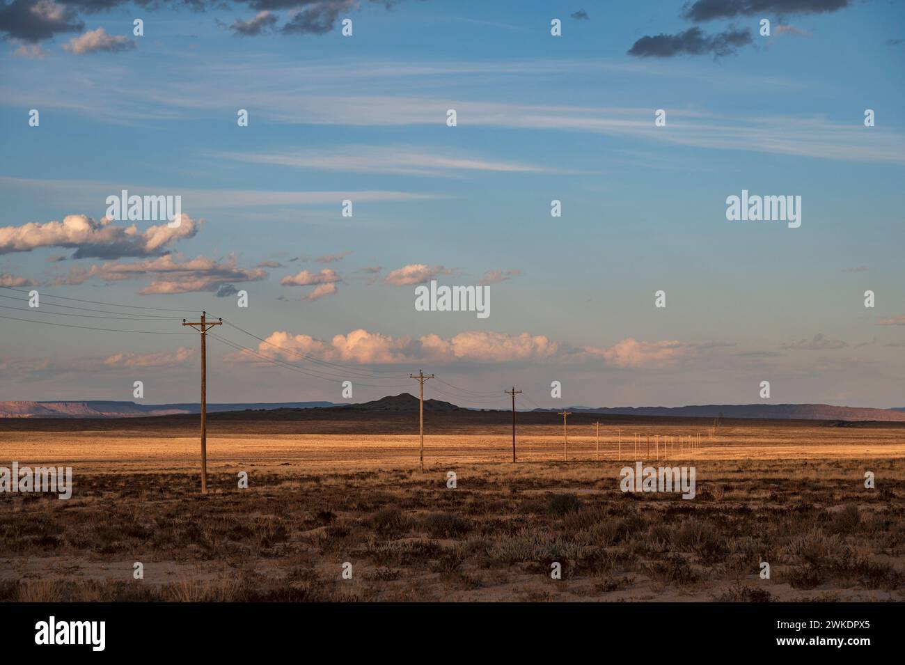 POWER LINES STREATCH ACROSS THE HIGH DESERT, SHIPROCK, NM, USA Stock Photo