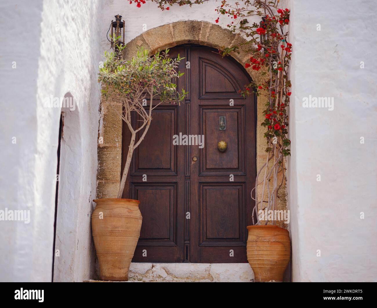 travel to city of Lindos on island of Rhodes, Greece. Details of streets of old town Lindos. Interesting elements of door, shutters, bas-relief of walls. tourist attraction on island of Rhodes Stock Photo