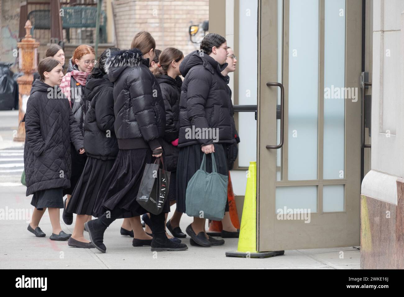 a group of young Jewish students enter their school minutes before first class. In Williamsburg, Brooklyn, New York. Stock Photo