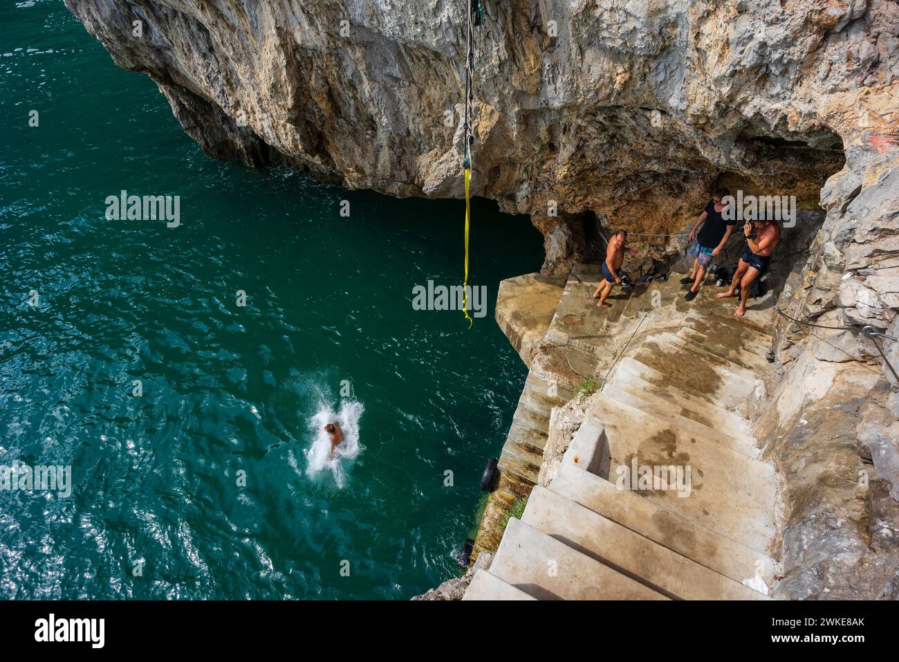 jumping into the sea, cliffs of Del Caballo lighthouse, Buciero mountain, Santoña, Cantabria, Spain. Stock Photo