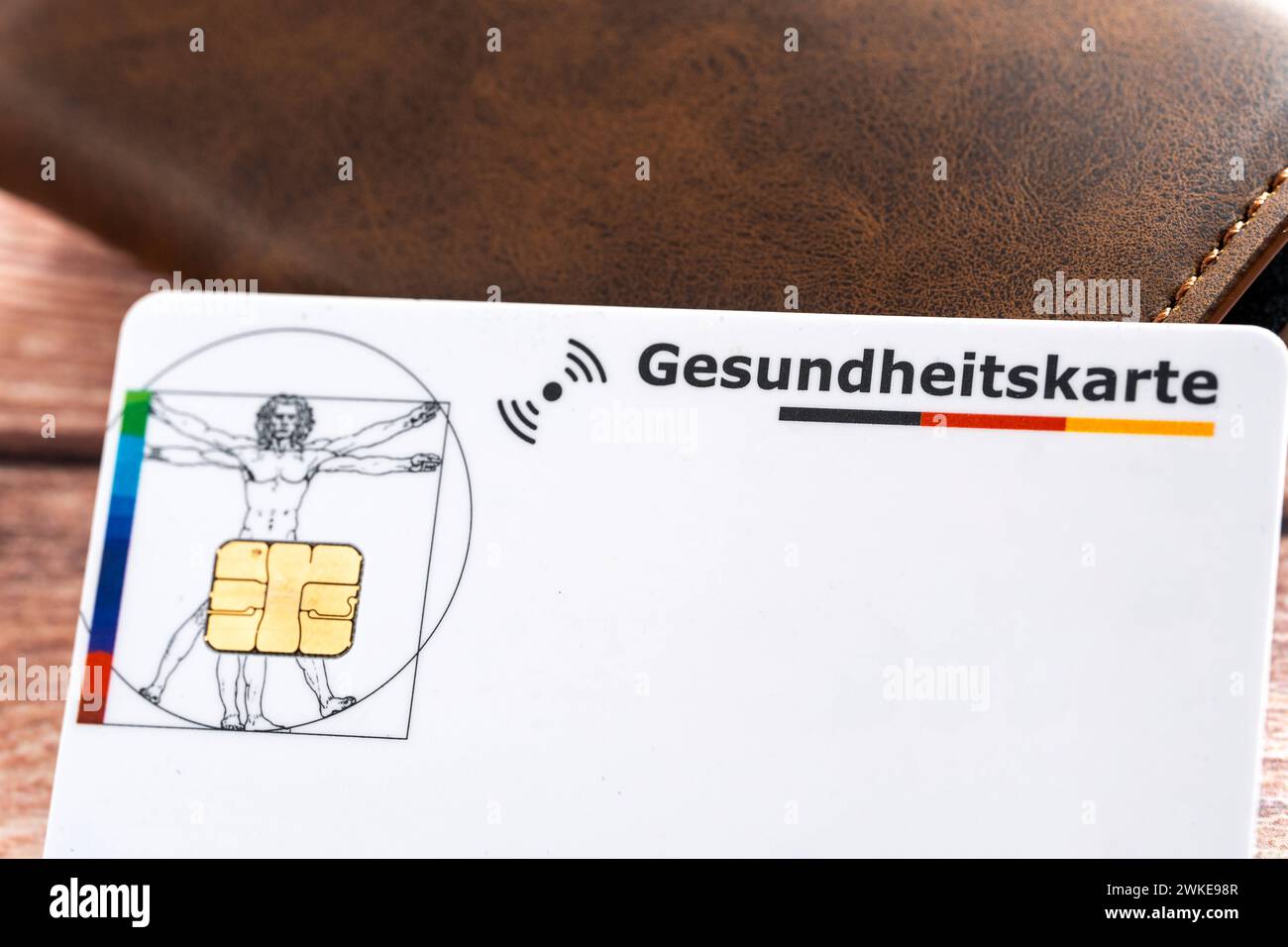 Augsburg, Bavaria, Germany - February 18, 2024: Health insurance card next to a wallet *** Gesundheitskarte einer Krankenkasse neben einer Geldbörse Stock Photo