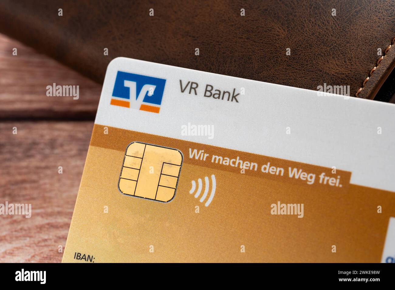 Augsburg, Bavaria, Germany - February 18, 2024: Volksbank Raiffeisenbank VR Bank EC card next to a wallet *** Volksbank Raiffeisenbank VR Bank EC-Karte neben einem Geldbeutel Stock Photo