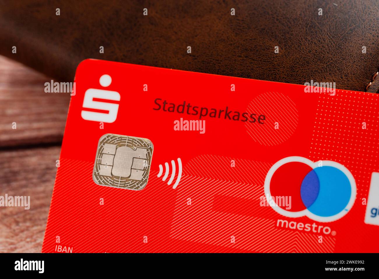 Augsburg, Bavaria, Germany - February 18, 2024: Sparkasse Bank EC card next to a purse *** Sparkasse Bank EC-Karte neben einem Geldbeutel Stock Photo
