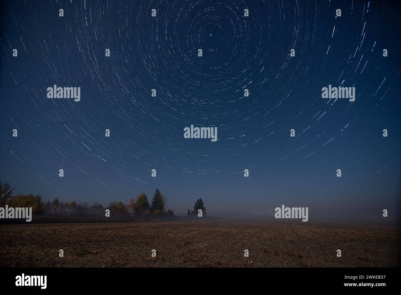 Movement of stars in the sky. Photo in the night field. Stock Photo