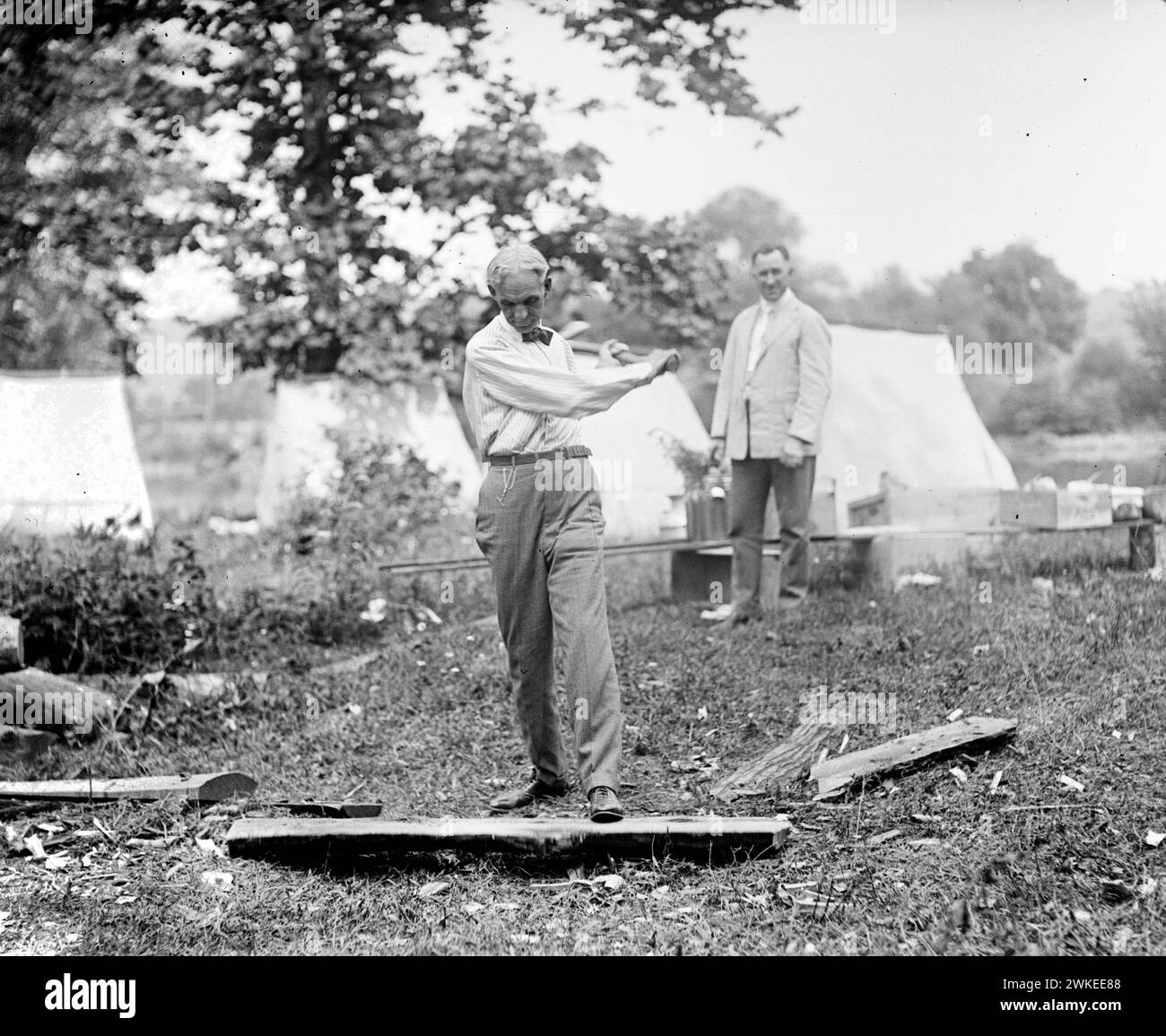 Founder of Ford Motor Company, Henry Ford, chopping wood in 1921 Stock