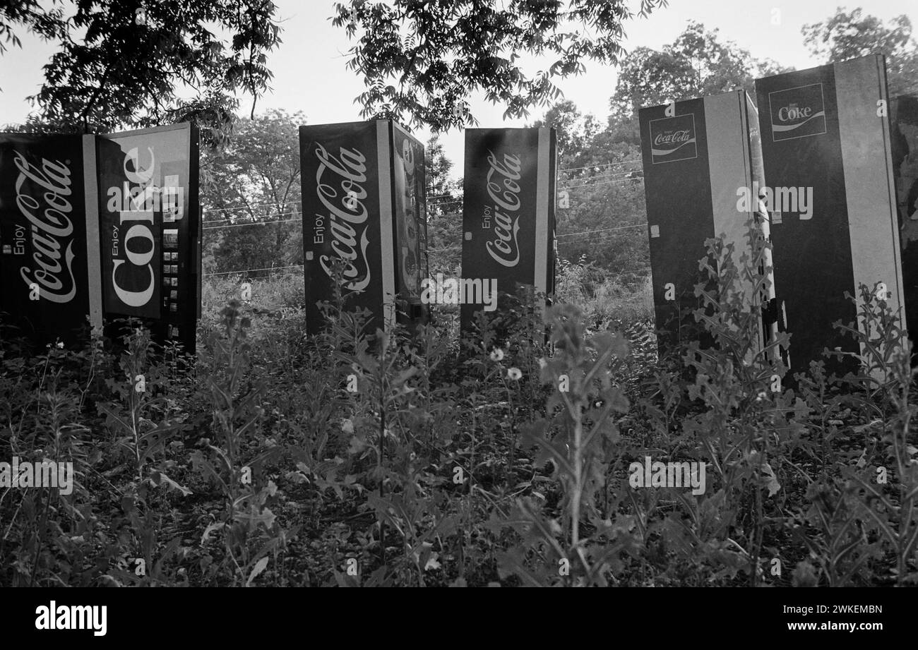 Coca-Cola vendng machines abandonded on wasteland in Georgia in the 1980s. Stock Photo