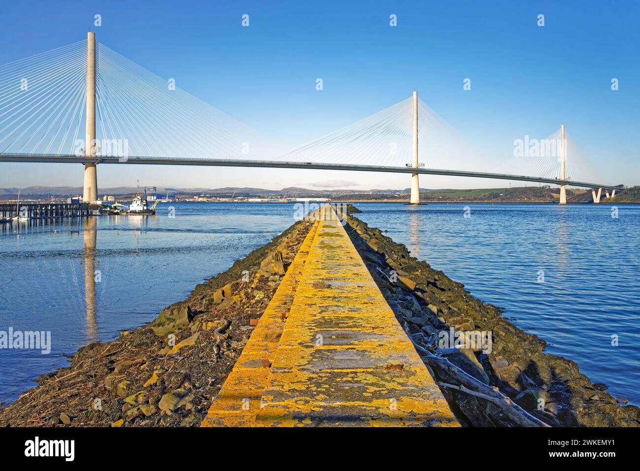UK, Scotland, South Queensferry, Port Edgar Marina Jetty and Queensferry Crossing over the Firth of Forth. Stock Photo